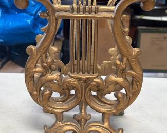 Lot 387: Hollywood Regency Cast Metal Lyre Magazine Rack