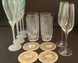 Four white brass coasters, four Lenox swirl pattern drinking glasses, four frosted base flutes, two Tiffany & Co. flutes