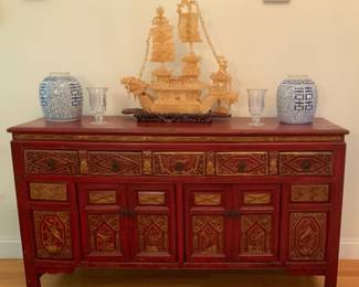 Reproduction “antique” Chinese red lacquered dresser. 61” W x 18 1/2” D x 34 3/4” H. Five drawers/two wide cabinets.