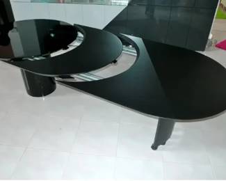 The middle crescent 'leaf' the table extends an additional 18 inches.