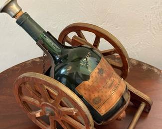 Vintage Courvoisier VSOP Cognac bottle in cannon-shaped carriage stand
