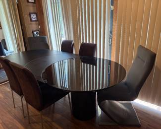 Available now!  Roger Rougier Extension Dining Table 42" pedestal dining table with a crescent moon extension and a 3 X larger section which supports the moving table base on casters.  Using the middle crescent 'leaf' the table extends an additional 18 inches.