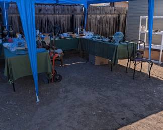 Back yard has several tents with items. this one has home decore, cooking untensils plus!