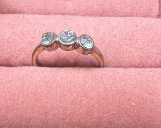 Three-stone bezel-set ring with clear stones