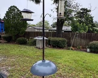 Multi-arm bird feeder pole with baffle and feeders