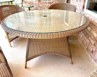 Table has umbrella hole and glass top