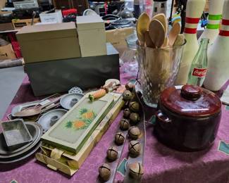 Sleigh bells, pottery, cheese cutting board, wooden spoons, bowling pins