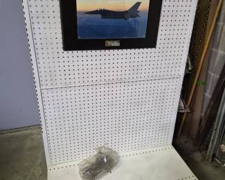 Display stand with pegboard and hanging brackets