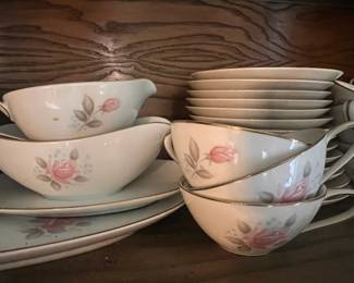Noritake Roseville China Set #6238.  Elegant procelain china set is white with a pink rose floral design with gold-toned trim. The large collection includes dinner plates, bowls, teacups, saucers, and a gravy boat.