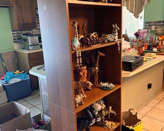 Tall bookcase with a brown wood-finish laminate. This piece has five open shelves and a solid back panel.