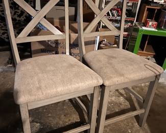 Rustic farmhouse-style X-back counter-height barstools with upholstered seats