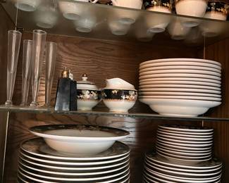 Elegant Mikasa Della Robbia fine china set. This ceramic dinnerware bundle features a dark floral border with gold-tone trim. The set includes dinner plates, salad plates, bowls, teacups, a creamer, and a sugar bowl.