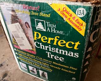 Christmas trees available! This one with revolving tree stand and also a 10 foot tree in a red vinyl storage bag.