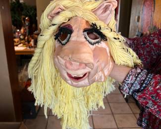 Vintage latex Miss Piggy mask has long blonde yarn hair. The mask is pink with black eyelashes and purple eyeshadow. It is a full-head costume piece with cutouts for the eyes and mouth. Lots of other costumes for Halloween, Cosplay, etc...