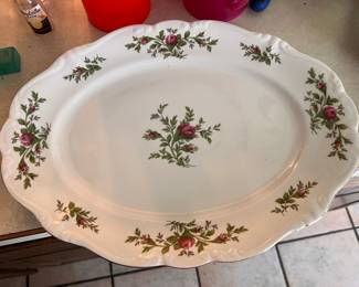 Elegant fine china serving platter from the Johann Haviland Traditions collection. This white oval dish has a scalloped edge and a pink rose floral pattern with green foliage. The underside has the manufacturer's mark.