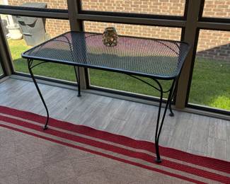 Iron table; outdoor rug