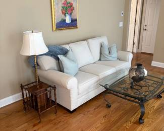 Sofa, iron table with glass top, original wall art, lamp table with magazine rack, pottery