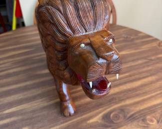 hand-carved wooden lion sculpture