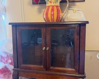 Small wooden cabinet with glass doors