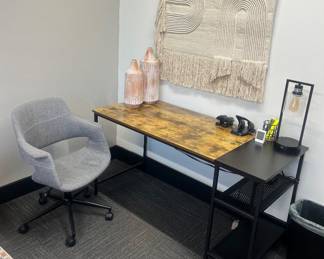 One of five matching office writing desks featuring a rustic brown wood-grain surface and a black metal frame with built-in lower storage shelves; one of eight matching LumiSource task chairs; excellent selection of modern decor for home or office.