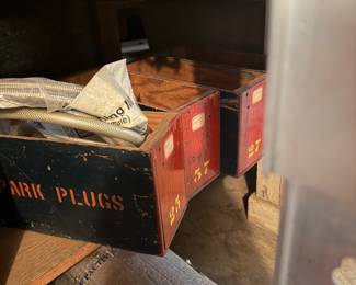 Wooden spark plug boxes with other things in them
