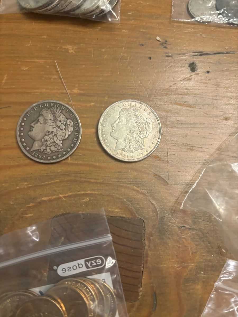 1892 and 1921 Morgan silver dollars, part of a larger U.S. coin collection