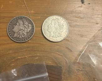 1892 and 1921 Morgan silver dollars, part of a larger U.S. coin collection