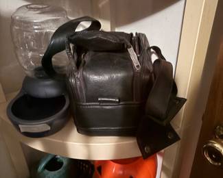 Camera case with camera, dog water feeder, cigar box, trick or treat pumpkin, waterer