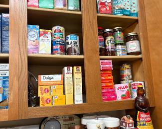 Cabinets in kitchen with lots of items