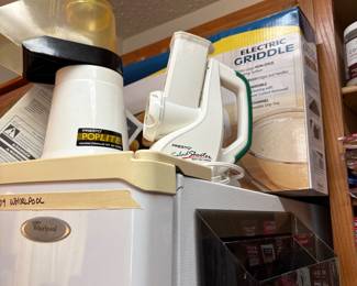 Items on top of kitchen refrigerator - Poplite popcorn popper, Salad shooter, Electric griddle & 2 holders that are attached to the fridge by magnets