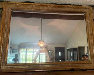 Dont overlook this gorgeous gold framed mirror above the fireplace
