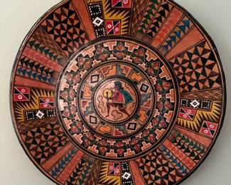 Handpainted Peruvian Aztec decorative plate features intricate geometric patterns and a central figure important to Andean Aztec culture