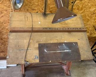 Vintage 1940s wooden drafting table, adjustable top, lower sliding reference surface, and articulated swing arm task lamp attachment