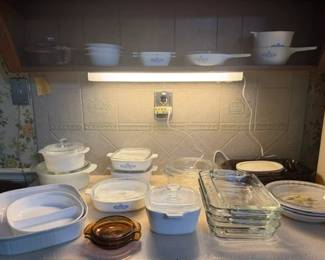 Lots of Corningware, some white, some blue and white, with lids