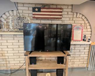 TV Stand, TV, and various wall art