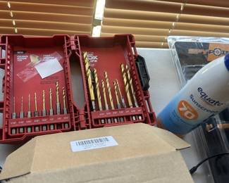 drill bits and small rechargeable flashlights in box