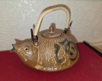 One of two Tanuki (raccoon dog) teapots or sake warmers