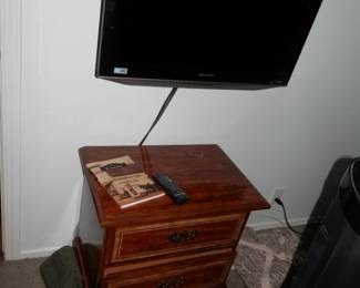 One of the nightstand that match the chest shown as a buffet....and a smaller flatscreen TV on a reticulating wall mount
