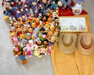 This lot includes a large group of small Disney character plush toys — Mickey, Minnie, Goofy, Pooh, Tigger, Eeyore, and many others — spread across the floor in the photo. Also included are a Winnie the Pooh serving tray, a framed Pooh print, a Pooh-decorated teapot, a yellow blanket or throw, and two straw sun hats. A high-piece-count lot for a Disney collector, resale, or a child's room.