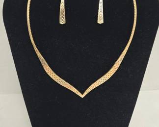 This vintage gold tone jewelry set pairs a coordinating necklace and earrings in a classic mid-century style that holds up beautifully today. Estate jewelry sets like this are a favorite among costume jewelry collectors for their coordinated look and retro elegance. A lovely addition to any vintage jewelry collection or a thoughtful gift for a jewelry enthusiast.