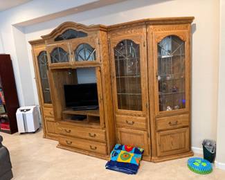5 piece oak entertainment center, beveled glass, lots of storage areas.
