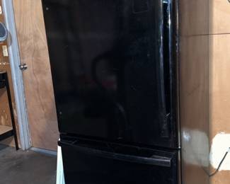 Black Whirlpool refrigerator with bottom freezer