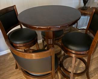Pub-height table with four cushioned swivel chairs
