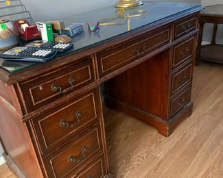 Traditional wood executive desk with glass top