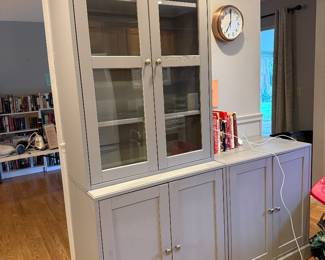 Gray storage cabinet with glass-front upper section