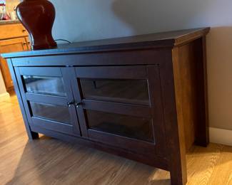 Dark wood TV/media console with glass-front doors