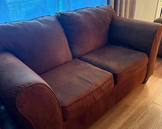 Brown upholstered loveseat