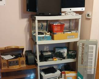 Yamaha PSR-11 keyboard, RCA speakers, Philco retro style hybrid music player, LG 22” TV, LG 26” TV, Lionel toy corp electric phonograph, Toshiba VHS player, portable radio, Sony DVD, HP printer, Apple IMac model A1419, portable DVD player, vinyl records