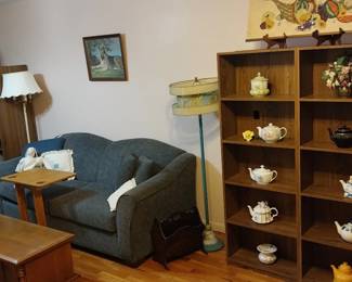 Best Craft sleeper sofa, wood book shelves, mid century atomic floor lamp, coffee table, tea pots, mosaic art
