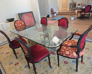 Glass Dining Table with Mirrored Base GLASS DINING TABLE WITH MIRRORED GEOMETRIC BASE Large glass-top dining table featuring a dramatic sculptural mirrored geometric base. Contemporary statement piece with substantial visual presence. Available during the weekend estate sale.